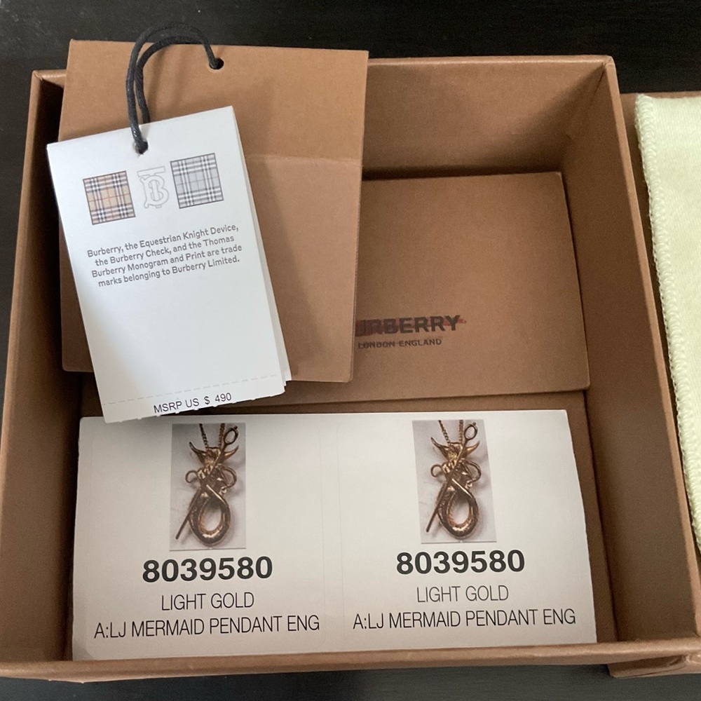 Burberry light gold mermaid pendant